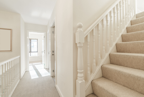 Bright small hallway with stairs in a house